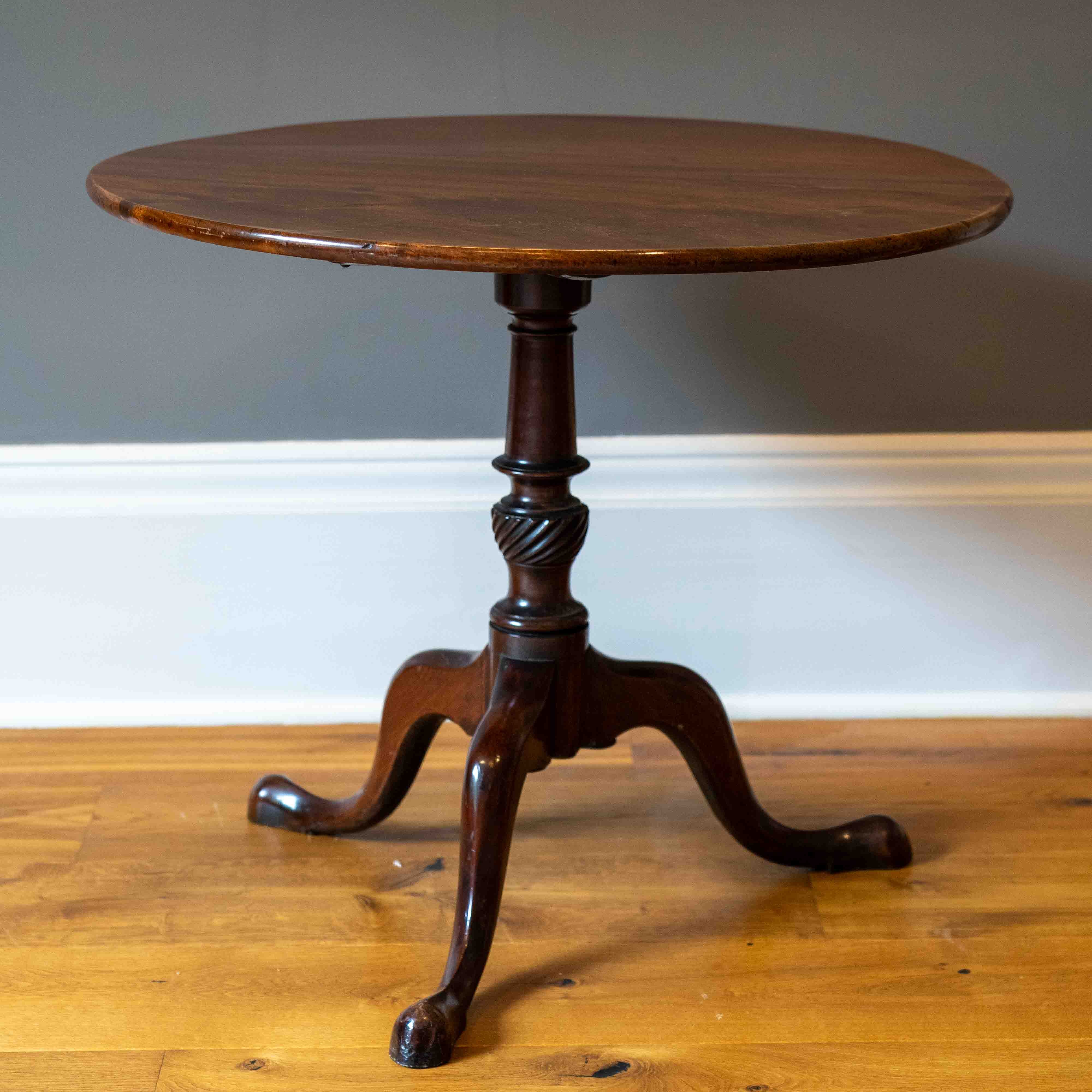 A George III circular mahogany tilt top tripod table, diameter 82cm, height 70cm. Condition - fair